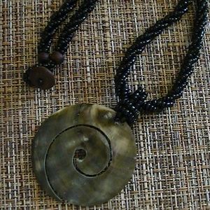 Abalone polished shell pendant on black seed rope